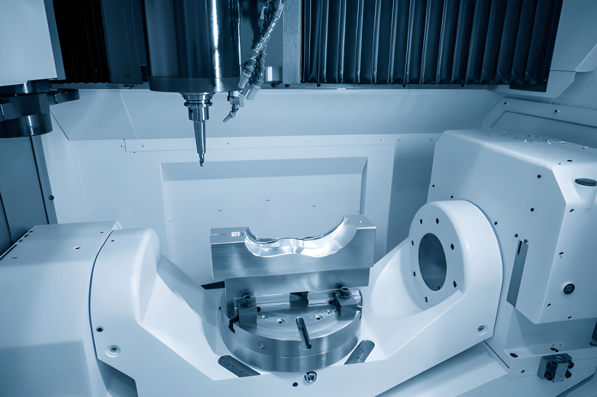 5-axis CNC machining center cutting the automotive mold part